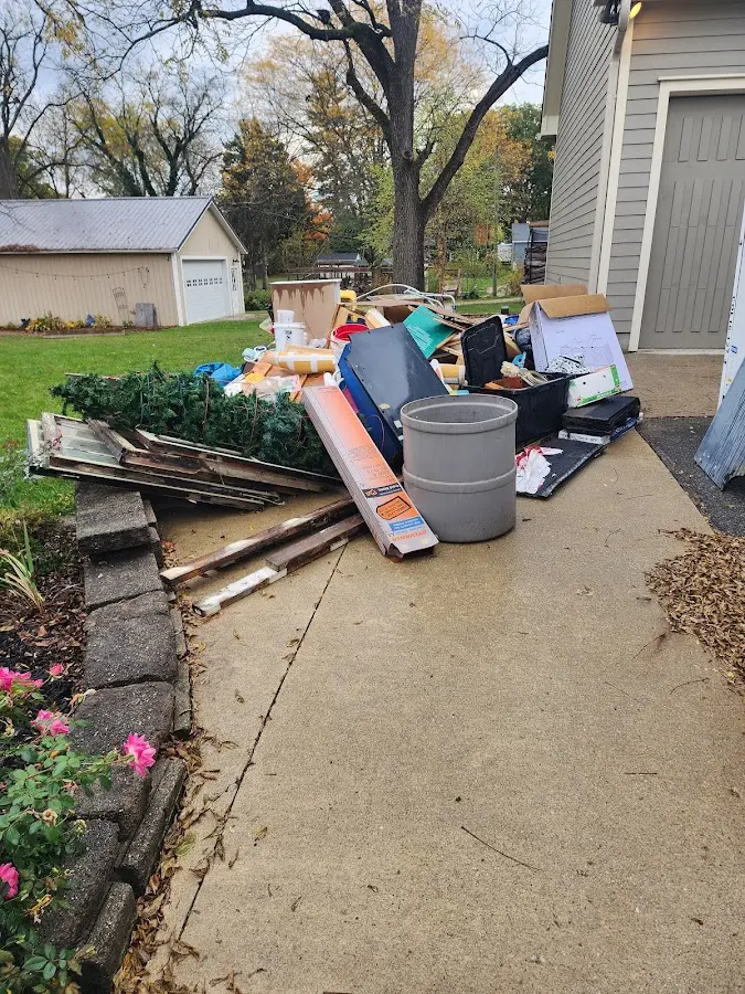 Dumpster being loaded with debris for Estate Cleanout Dumpster Rental in Santaquin